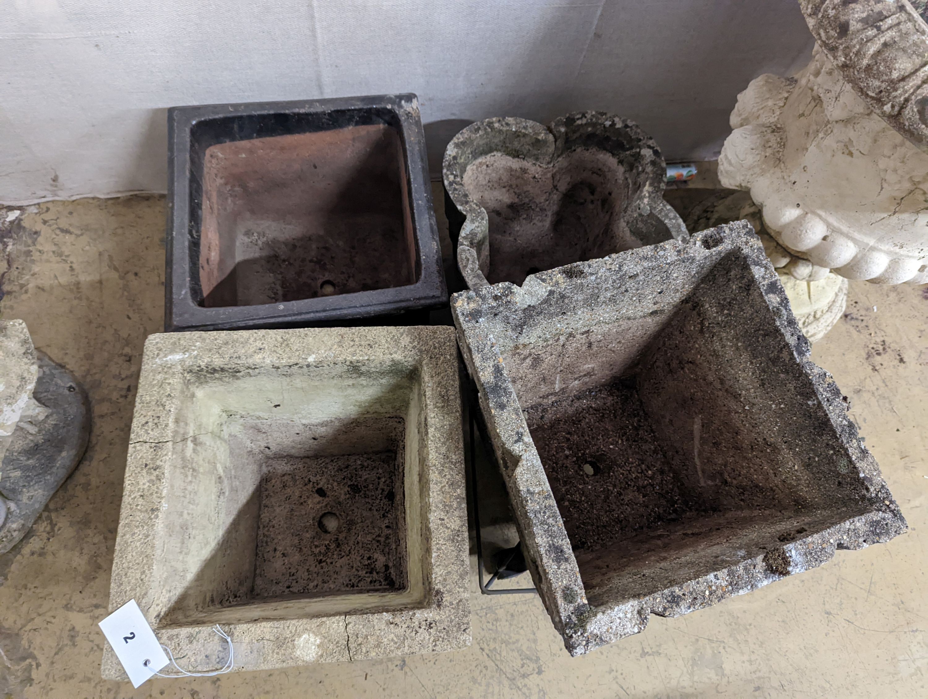 Three reconstituted stone garden planters and a terracotta planter, largest width 36cm, height 35cm